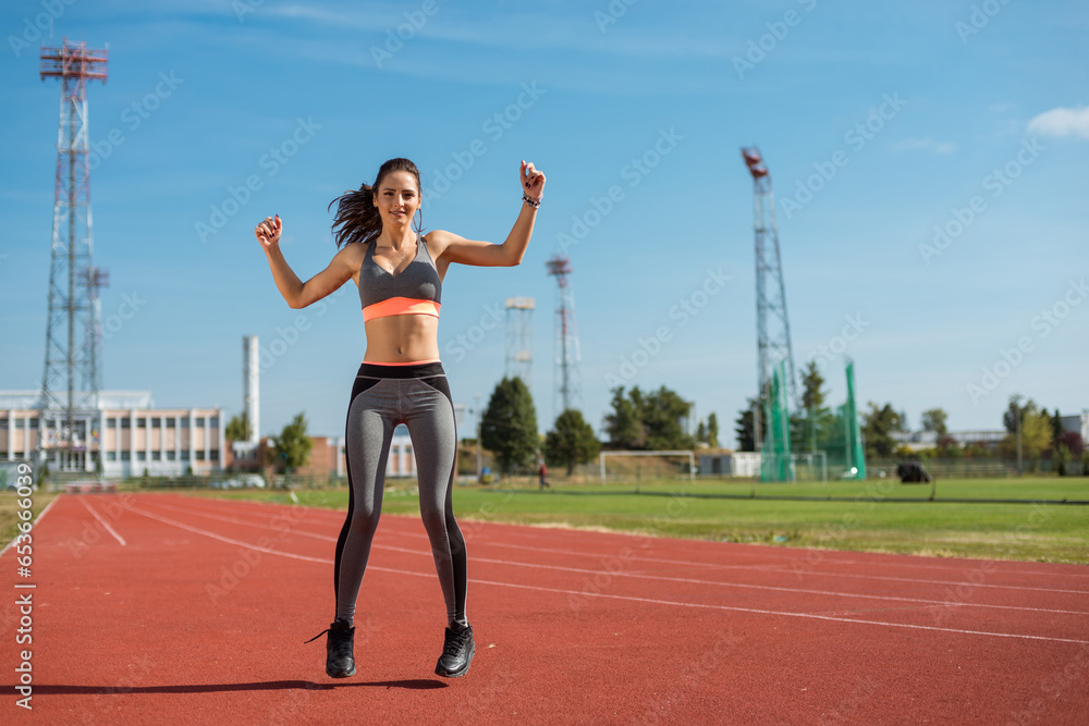 Beautiful woman training on the tracks on a sunny morning