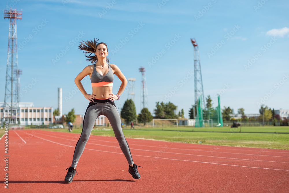Beautiful woman training on the tracks on a sunny morning