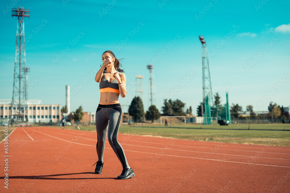 Beautiful woman training on the tracks on a sunny morning
