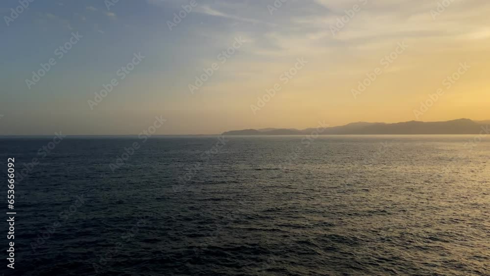 sea and a lighthouse on a cliff at sunset sea and a lighthouse on a cliff at sunset