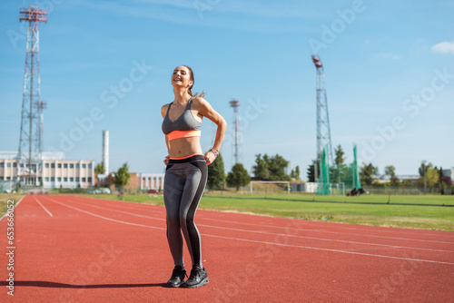 Obraz na płótnie Beautiful woman training on the tracks on a sunny morning w salonie