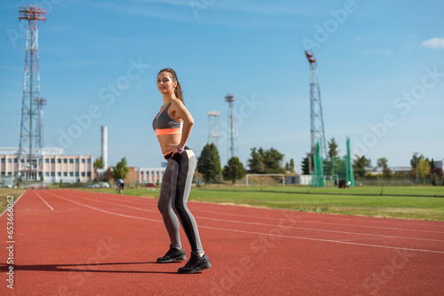 Obraz na płótnie Beautiful woman training on the tracks on a sunny morning w salonie