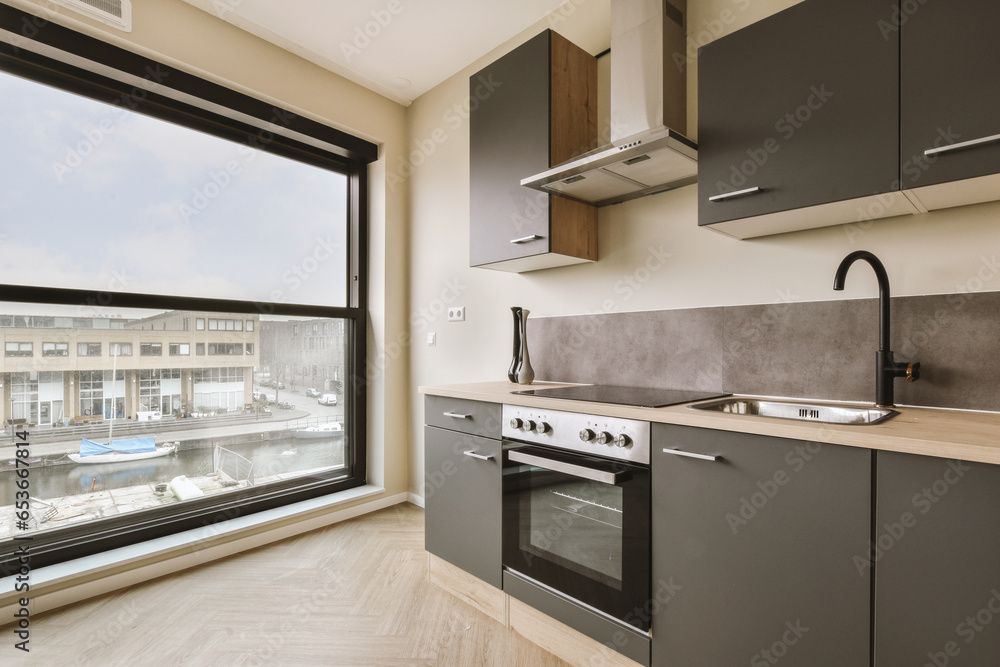 Kitchen with cabinets and appliances by window Kitchen with cabinets and appliances by window