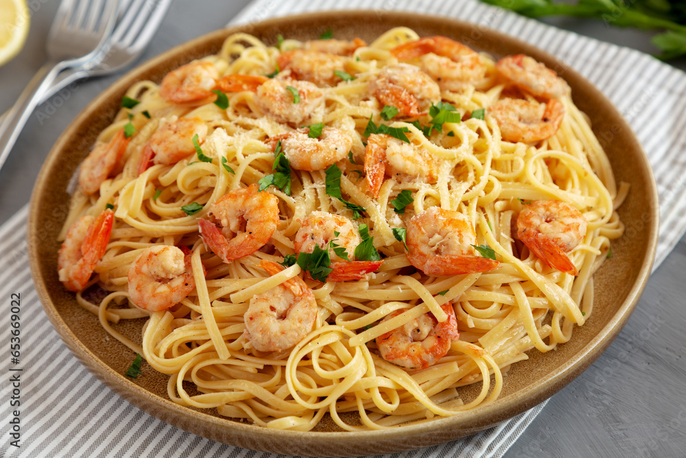 Baked Shrimp Scampi Linguine Pasta with Parsley on a Plate, side view. Close-up.