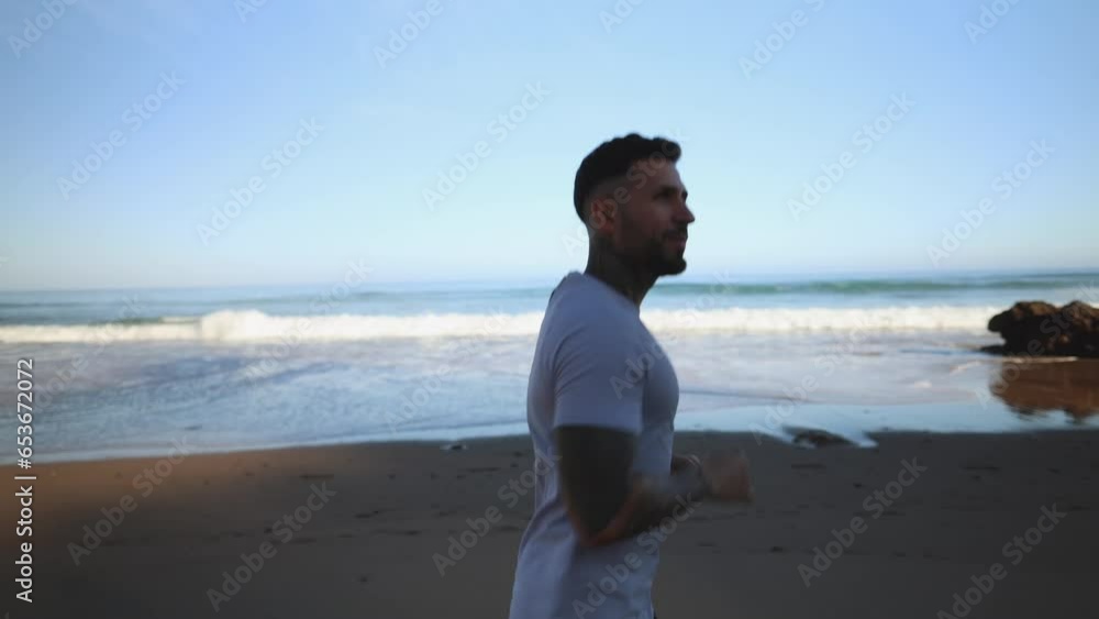 young adult latin man running on the beach young adult latin man running on the beach