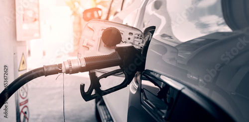 Car at gas station with pump, fuel and transport cost for energy, drive and quality petrol service. Travel, gasoline and motor vehicle maintenance at garage to refuel tank with diesel for road trip.