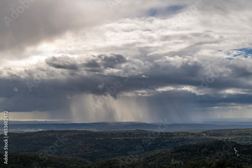 Sun rays shining through rainclouds showing the falling rain in Northern Israel looking towards the Mediterranean Sea from Muhraqa viewpoint. 