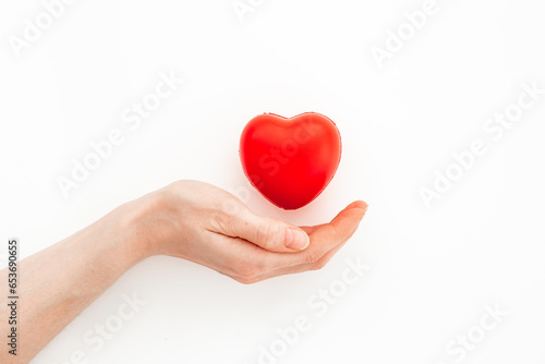 Medical and health care concept - heart with female hands