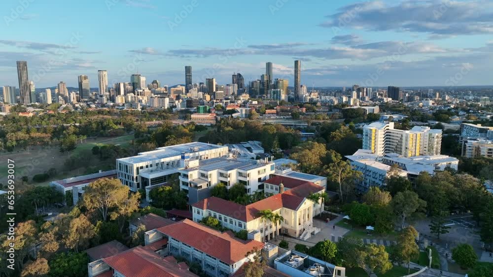 QUT Queensland University of Technology drone shot. Push in shot of Kelvin Grove University Campus. Kelvin Grove, Victoria Park, Brisbane City in Background. Shot in sunset afternoon light. QUT Queensland University of Technology drone shot. Push in shot of Kelvin Grove University Campus. Kelvin Grove, Victoria Park, Brisbane City in Background. Shot in sunset afternoon light.