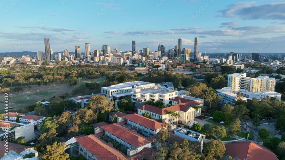 QUT Queensland University of Technology drone shot. Pull away shot of Kelvin Grove University Campus. Kelvin Grove, Victoria Park, Brisbane City in Background. Shot in sunset afternoon light. QUT Queensland University of Technology drone shot. Pull away shot of Kelvin Grove University Campus. Kelvin Grove, Victoria Park, Brisbane City in Background. Shot in sunset afternoon light.
