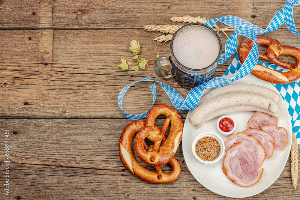 Traditional Oktoberfest set. Pretzels, beer, weisswurst, eisbein with mustard. German festival food Traditional Oktoberfest set. Pretzels, beer, weisswurst, eisbein with mustard. German festival food