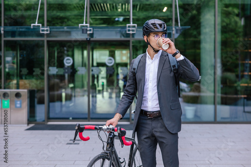 Elegant businessman in hemlet with electric scooter photo