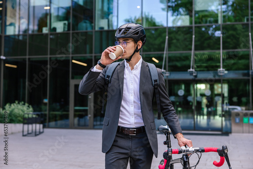 Elegant businessman in hemlet with electric scooter photo