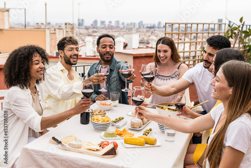 Sticker Happy group of friends toasting with wine glasses in a terrace