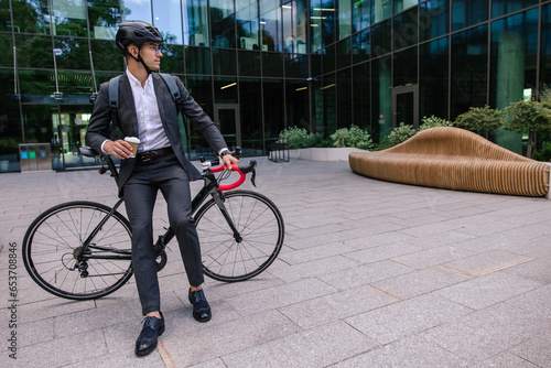 Young businessman wearing protective hemlet before cycling