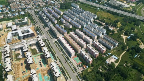 Aerial over residential area with apartments, ever-evolving urban landscape in Huayin, a city nestled in the heart of Shaanxi Province, China. City's rapid development and growth concept. UHD. photo