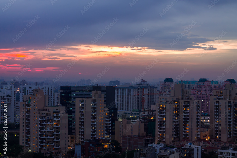 Obraz premium Gurugram,Haryana,India urban cityscape with modern architecture,luxury residential and commercial buildings.Aerial view of Gurgaon skyline at sunset.