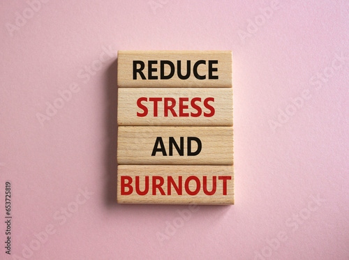 Reduce Stress and Burnout symbol. Concept word Reduce Stress and Burnout on wooden blocks. Beautiful pink background. Business and Reduce Stress and Burnout concept. Copy space