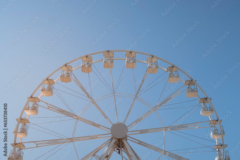 Ferris wheel against blue sky. Background