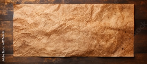 Brown baking paper with wood background and copy space photo