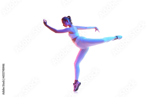 Full length portrait of young flexible woman posing in sportswear isolated white background in neon light.