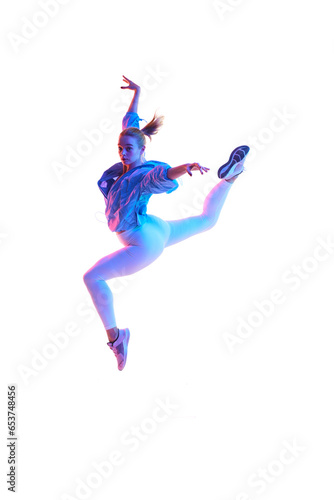 Full length portrait of young flexible woman posing in air in sportswear isolated white background in neon light.
