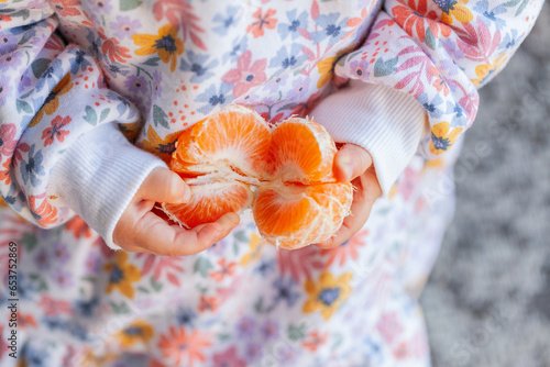 Child ready to eat healthy mandarin citrus fruit photo