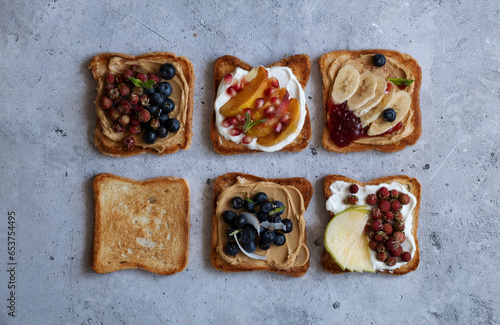 Sweet toasts made from fresh berries, jam, peanut butter and honey. Healthy toasts made from berries and fruits