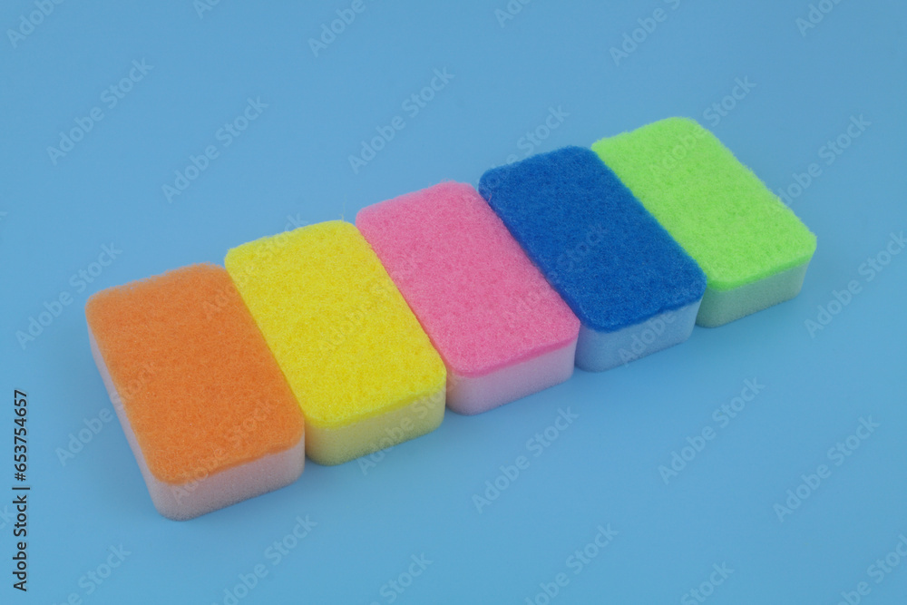 Different sponges in a row on blue background. Different sponges in a row on blue background.