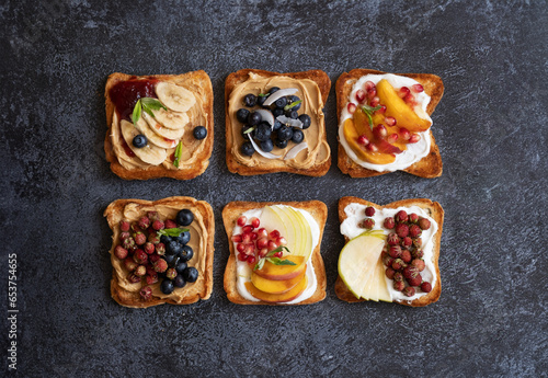 Sweet toasts made from fresh berries, jam, peanut butter and honey. Healthy toasts made from berries and fruits