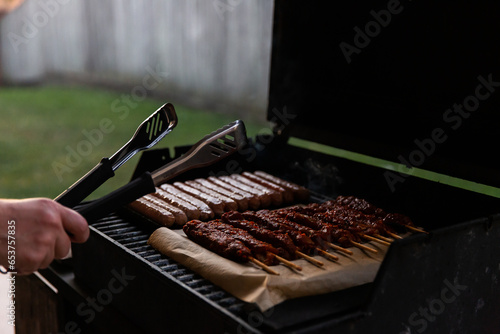 sausages and kebabs cooking on a barbecue photo