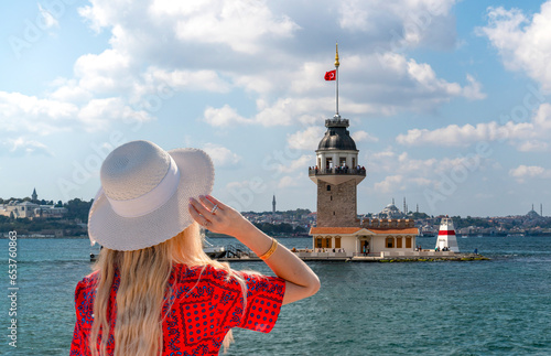 The Maiden's Tower (Turkish: Kız Kulesi), also known as Leander's Tower (Tower of Leandros) and tourist girl watches the tower from Salacak Uskudar beach. photo