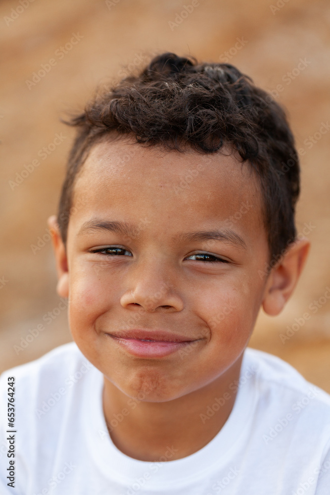 Portrait of a young aboriginal child against brown australian earth Portrait of a young aboriginal child against brown australian earth
