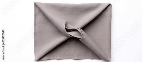 Top view of white background with folded cotton napkin in grey