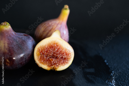 Delicious ripe figs on a black background