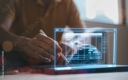 Fototapeta Naklejka Na Ścianę i Meble -  Data analysis concept, An analyst use tablet for data business analysis and Data Management System with KPI and metrics connected to the database for technology finance, operations, sales, marketing