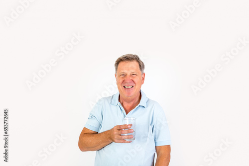 positive senior man drinking a glass of water