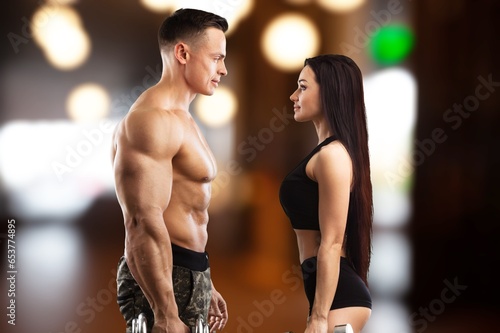 Strong, sporty couple training in a gym