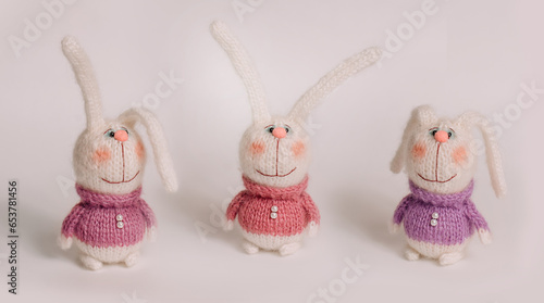 Wallpaper Mural Handmade knitted bunnies stand against a white background. Postcard for congratulations on the New Year and Christmas holiday. Torontodigital.ca