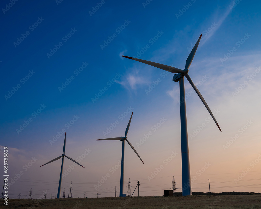 Windmills at sunset. Alternative energy source. Windmills at sunset. Alternative energy source.