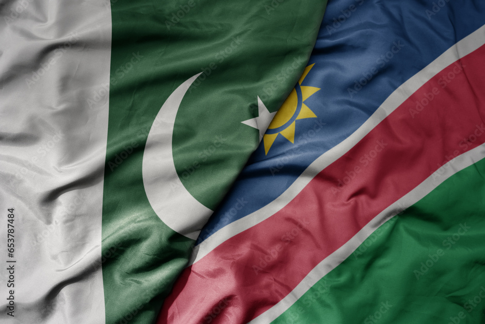 Obraz premium big waving realistic national colorful flag of pakistan and national flag of namibia .