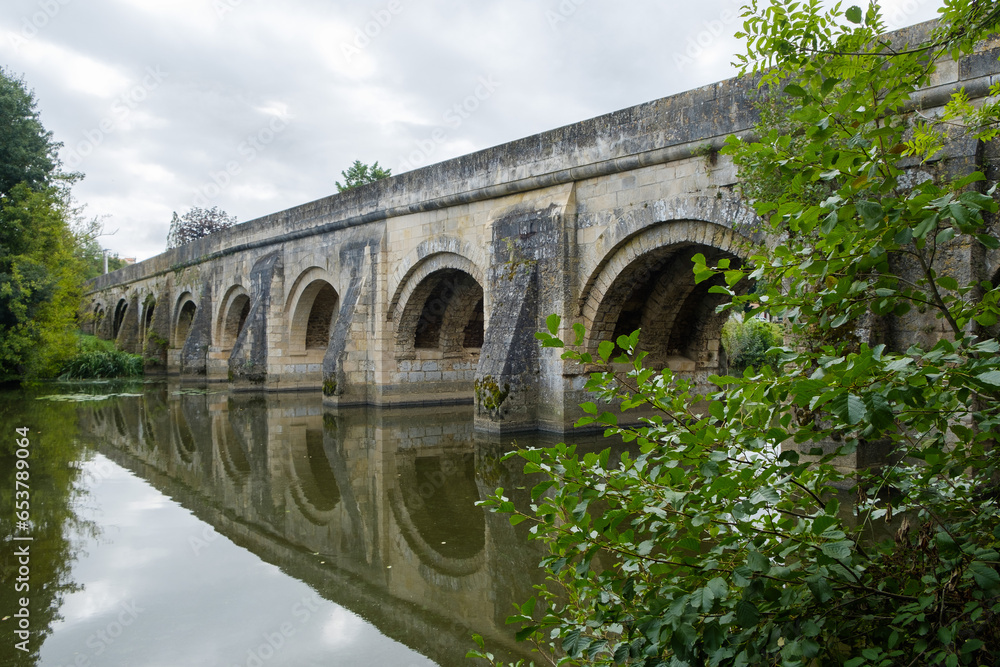 Fototapeta premium Pont du Vernay, 12th century ancient bridge over the river Thouet at Airvault, Deux-Sèvres, Nouvelle-Aquitaine, France