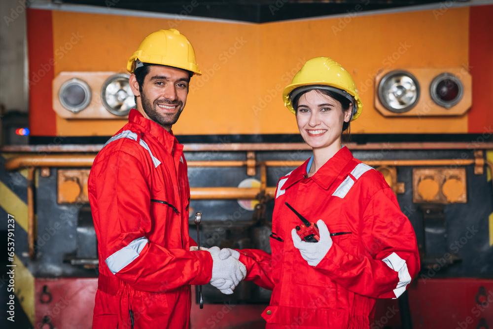 Team engineers and foreman stack hand and shake hands to show success at factory machines. Team engineers and foreman stack hand and shake hands to show success at factory machines.