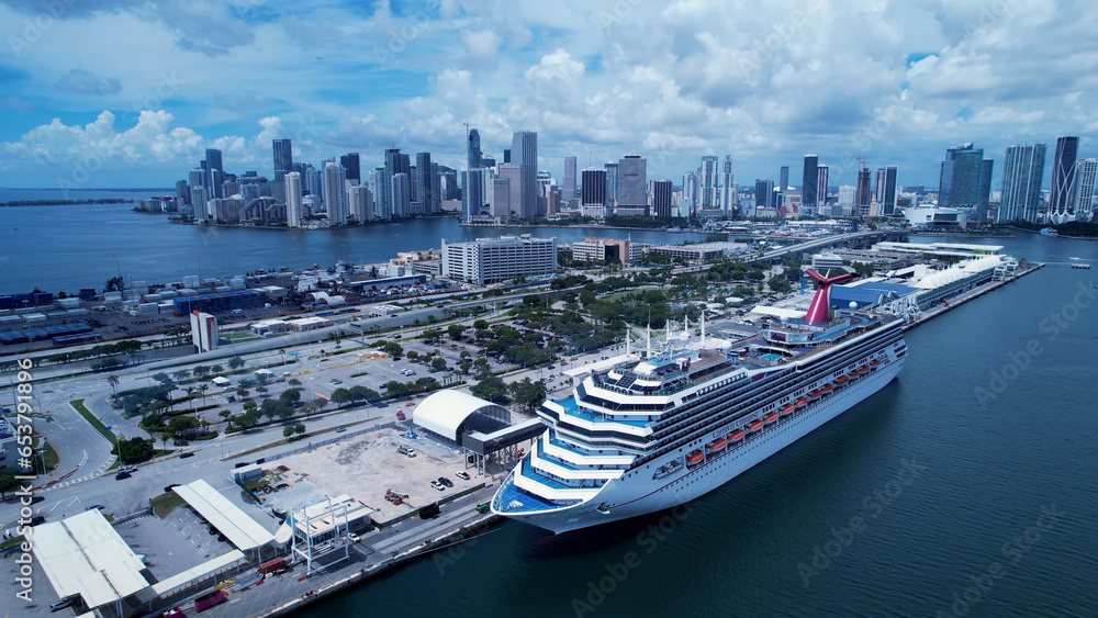 Fototapeta premium Aerial landscape of stunning Cruise ship at port of Miami dock station. Miami Florida. Miami United States. Travel destinations. Vacations travel. Cityscape Miami Florida United States. 