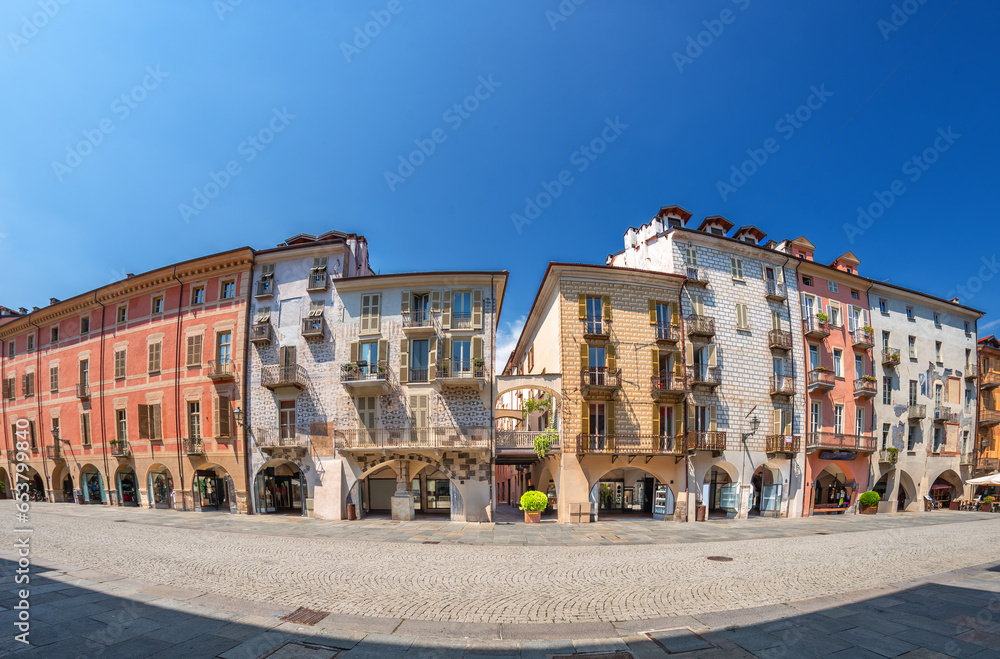 Cuneo, Piedmont, Italy - August 16, 2023: Cityscape on Roma Street main pedestrian cobblestone street with Ancient buildings decorated and with arcade in historic center, fisheye vision