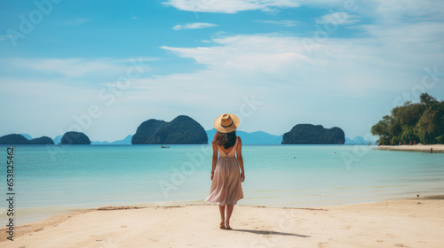 young woman wears a dress and travels to the beach in the summer alone on her vacation. At andaman sea Laem Had Beach