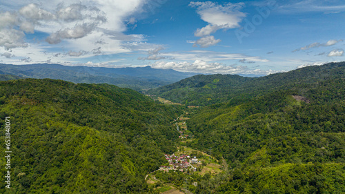 Valley among the mountains with farmland in the tropics of Sumatra. Indonesia.