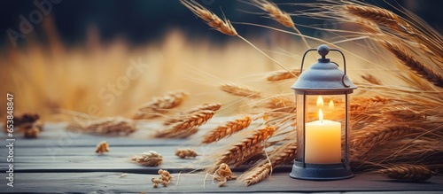 Summer harvest symbol handmade lantern and wheat on garden table natural background Represents Lammas LughAIdh pagan holiday wiccan sabbat witchcraft ritual