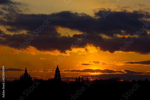 fiery sunset with clouds and silhouette of the cathedral in the foreground