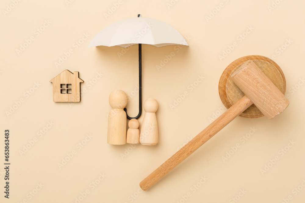 Wooden family figures with judge's gavel on color background,top view Wooden family figures with judge's gavel on color background,top view